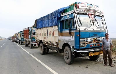Pulwama: Trucks remain stranded on Jammu-Srinagar Highway at Pampore after protesters pelted stones at Lethpora, Awantipora in Jammu and Kashmir