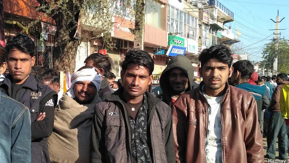 Daily wage workers wait for contractors at a market square in Jaipur. 