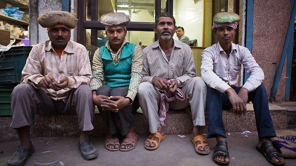 Jhalliwalas of Chawri Bazar, Old Delhi, waiting for work in the evening. 