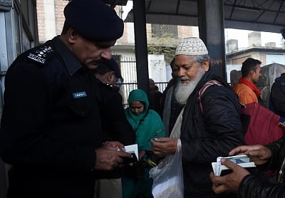 LAHORE, March 5, 2019 (Xinhua) A policeman checks documents of a passenger traveling with the Samjhota Express at a railway station in eastern Pakistan