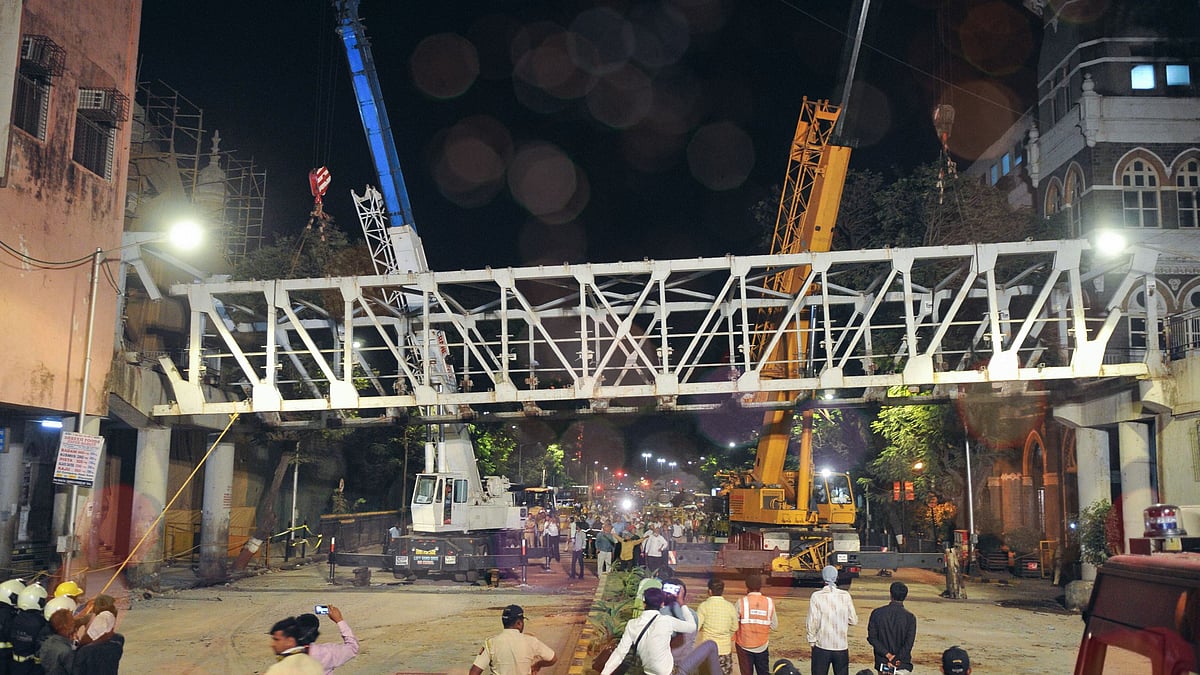In this picture from 15 March, 2019, civic authorities are seen dismantling the bridge connecting the CST station and the are ear the TOI building, after it collapsed 14 March.
