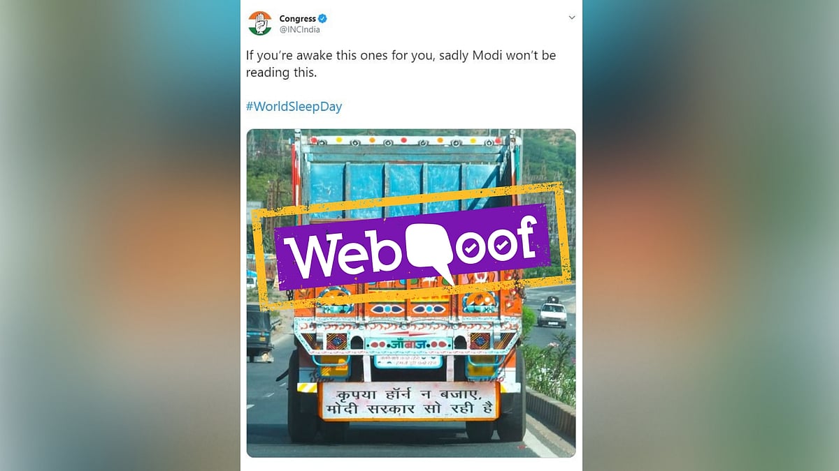 The image of the truck has been photshopped to add a signboard that is critical of the Modi government.
