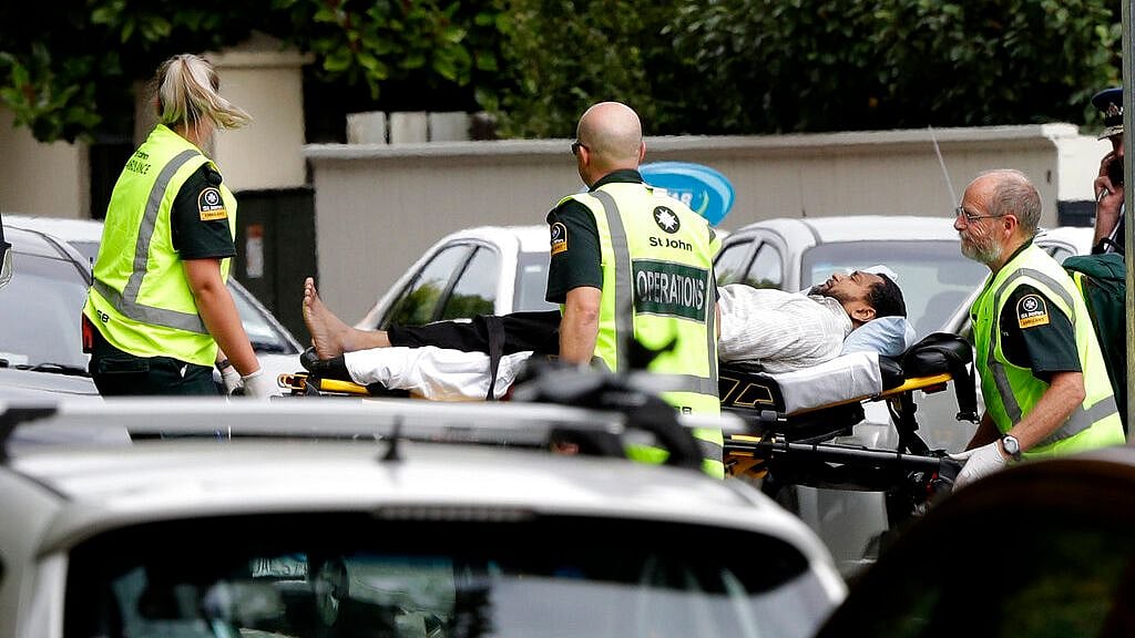 Ambulance staff take a man from outside a mosque in central Christchurch, New Zealand, Friday, March 15, 2019. 