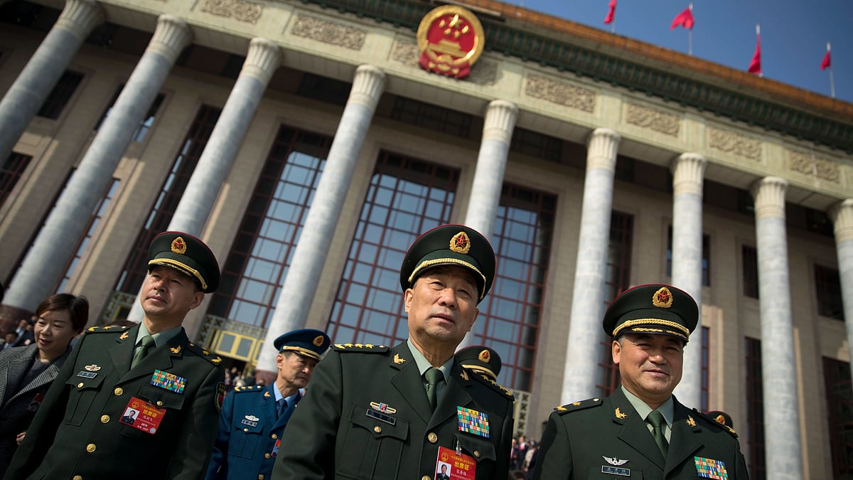 In this 4 March 2019 photo, military delegates leave after a meeting one day before the opening session of China’s National People’s Congress (NPC) at the Great Hall of the People in Beijing. To a remarkable degree, the Pentagon’s new budget proposal is shaped by national security threats that Acting Defense Secretary Patrick Shanahan has summarized in three words: “China, China, China.”