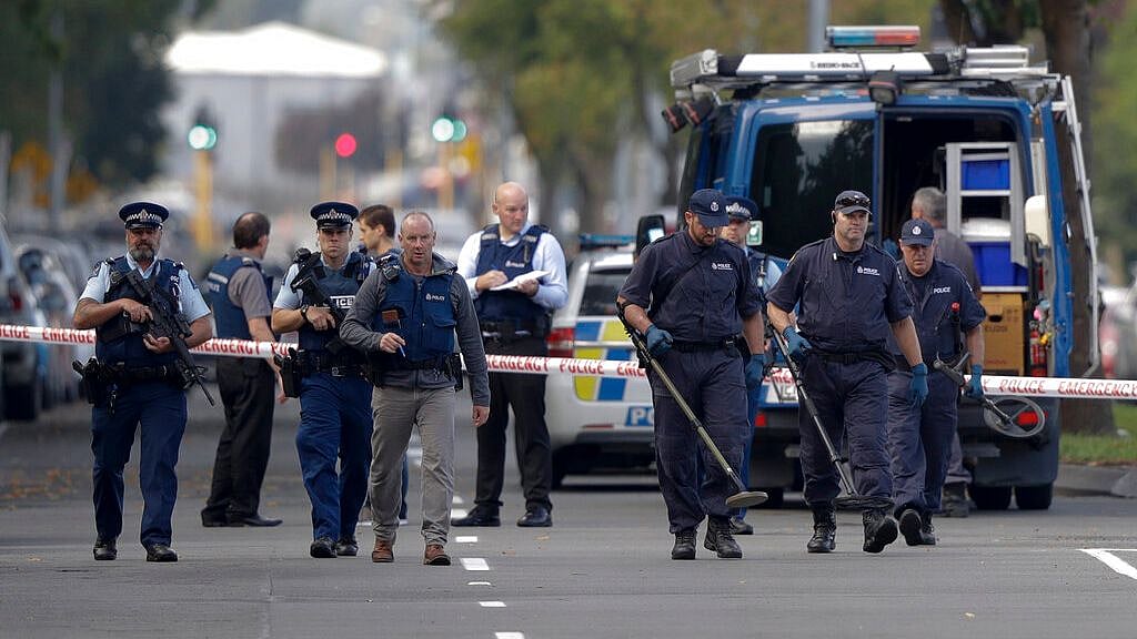 Police officers search the area near the Masjid Al Noor mosque, site of one of the mass shootings at two mosques in Christchurch, New Zealand on 16 March 2019. 