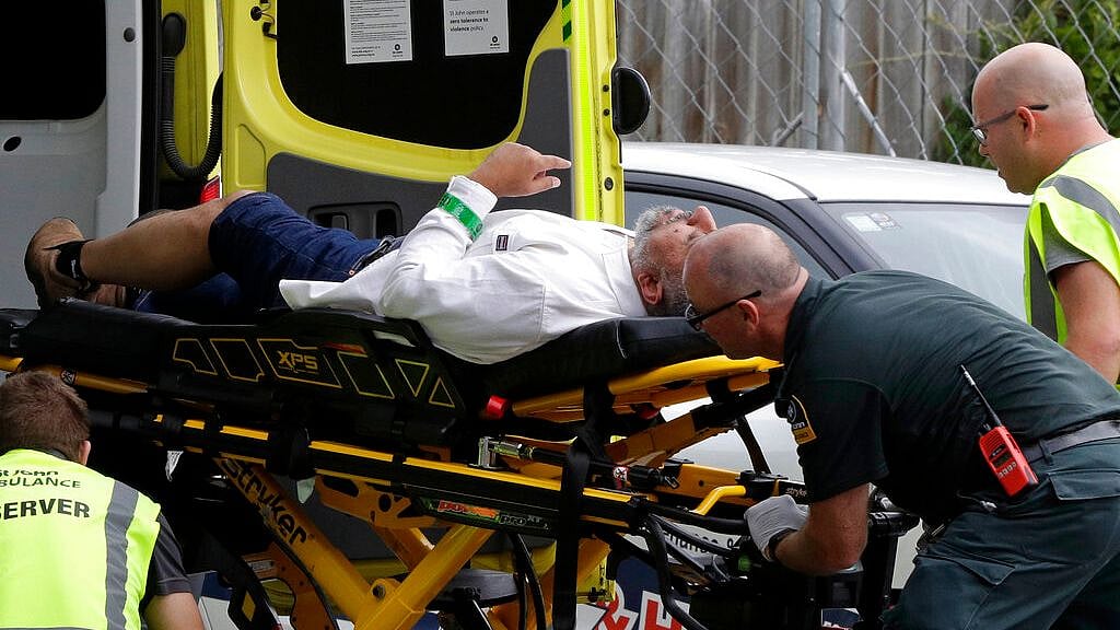 Ambulance staff take a man from outside a mosque in central Christchurch, New Zealand, on 15 March 2019, following a mass shooting.