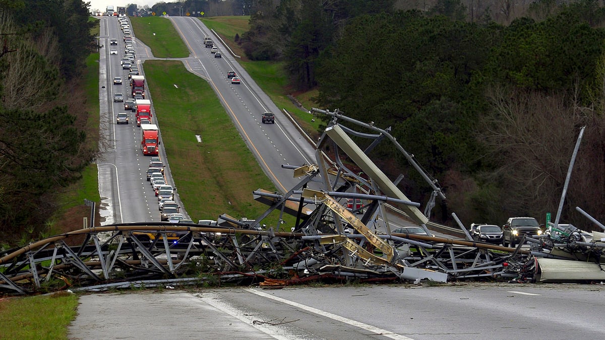 A fallen cell tower lies across US Route 280 highway in Lee County, Alabama, in the Smiths Station community.