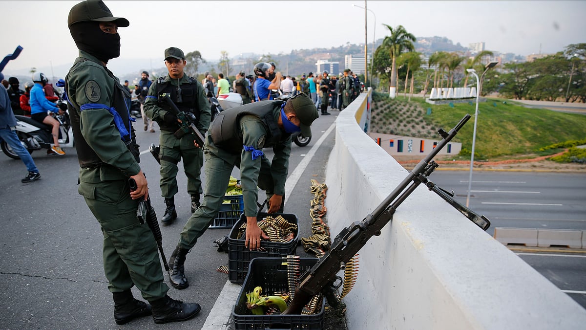 Soldiers take position on an overpass next to La Carlota air base in Caracas, Venezuela, Tuesday, 30 April.