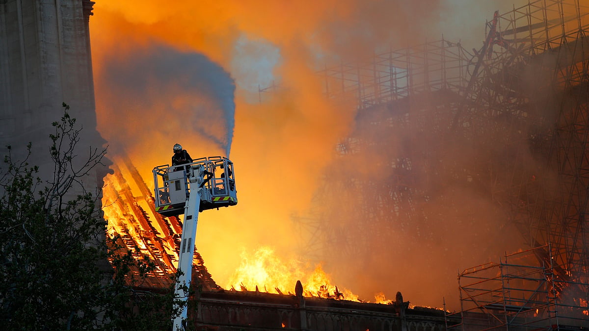 A fire fighter uses a hose at Notre Dame cathedral in Paris