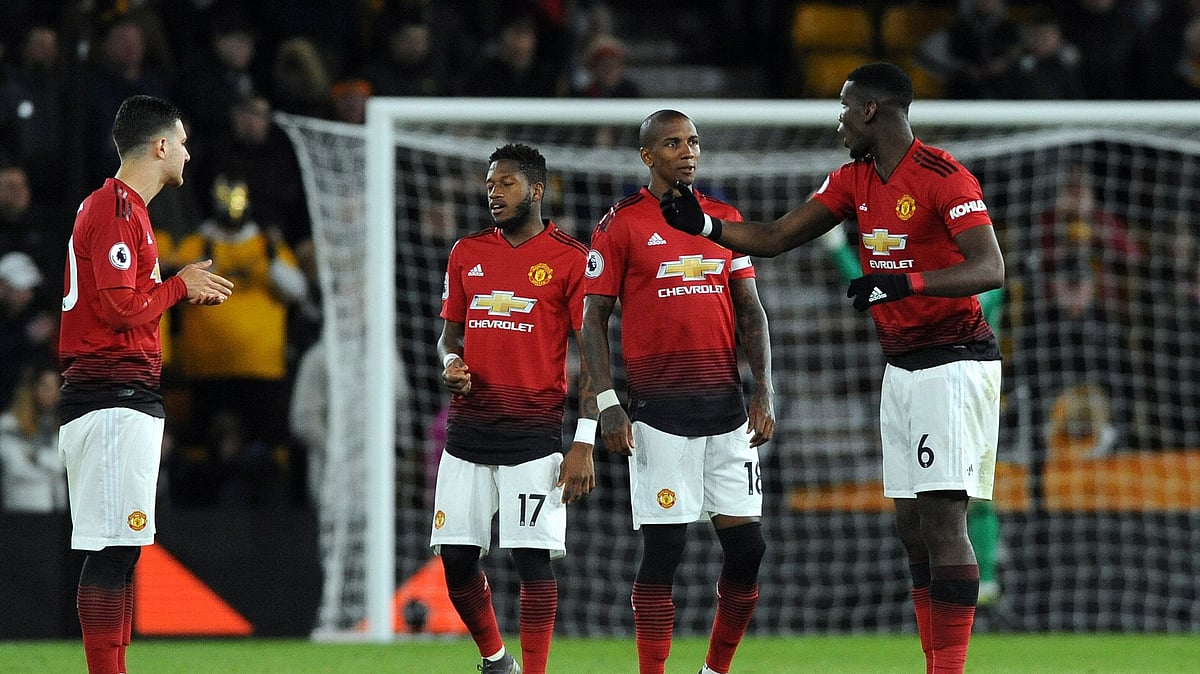 Manchester United’s Paul Pogba, right, talks to teammate Ashley Young during the English Premier League soccer match between Wolverhampton Wanderers and Manchester United at the Molineux Stadium in Wolverhampton, England, Tuesday, April 2, 2019. 