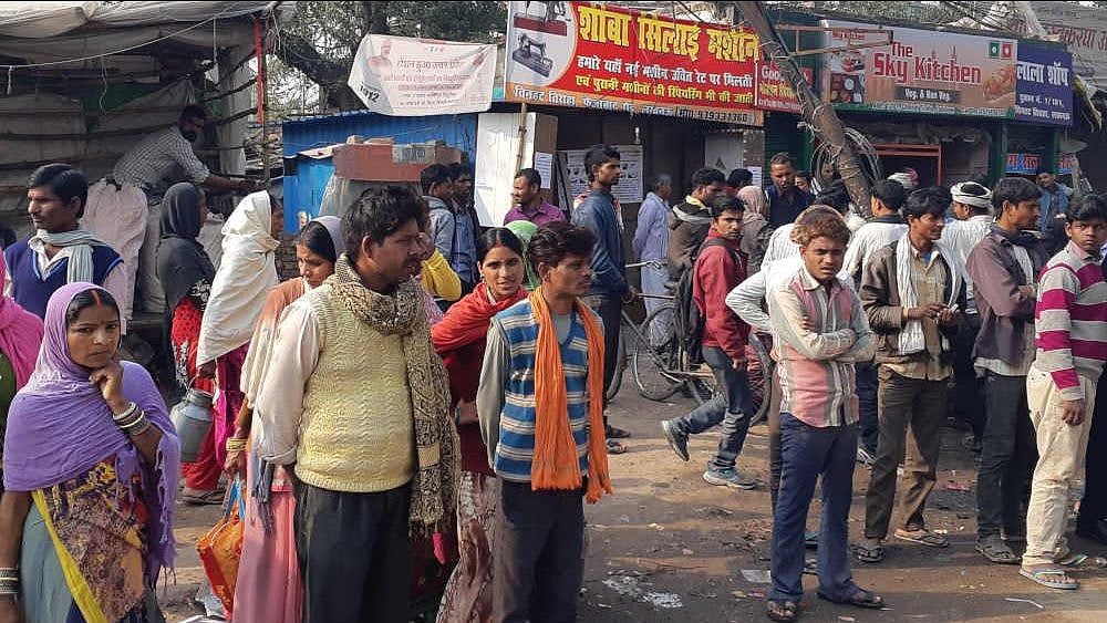 Workers waiting at the Chinhat labour hub.