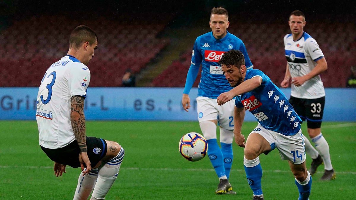 Napoli’s Dries Mertens, right, and Atalanta’s Gianluca Mancini vie for the ball during the Italian Serie A soccer match.