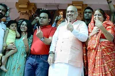 Ahmedabad: BJP President Amit Shah accompanied by his wife Sonal Shah, son Jay Shah, daughter-in-law Rishita Patel and granddaughter, shows his forefinger marked with indelible ink after casting vote during the third phase of Lok Sabha polls, in Ahmedabad, Gujarat on April 23, 2019. (Photo: IANS)