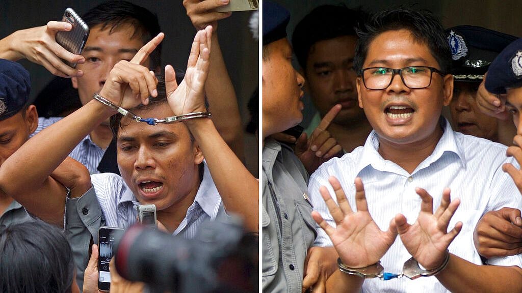 Reuters journalists Kyaw Soe Oo, left, and Wa Lone, are handcuffed as they are escorted by police out of a court in Yangon, Myanmar.