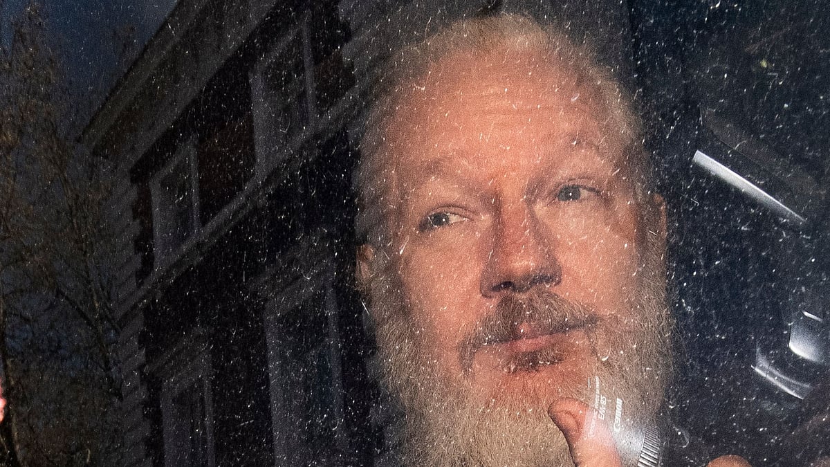 Julian Assange gestures as he arrives at Westminster Magistrates’ Court in London, after the WikiLeaks founder was arrested by officers from the Metropolitan Police and taken into custody Thursday 11 April 2019. 