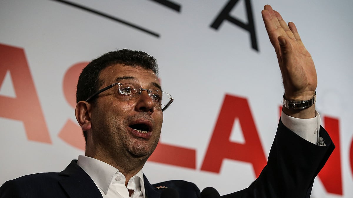 Ekrem Imamoglu, the candidate from an alliance led by the secular Republican People’s Party, (CHP) gestures as he declares victory during a news conference. 