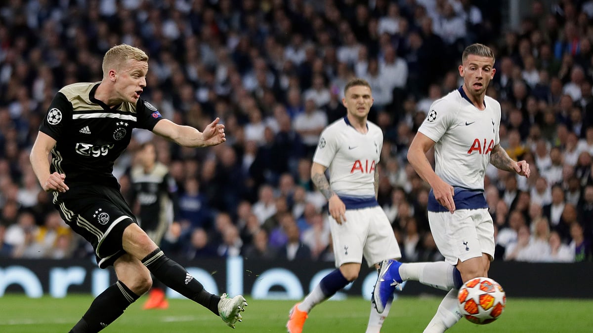 Ajax’s Donny van de Beek puts the ball in the net as Tottenham defenders Alderweireld and Trippier look on.