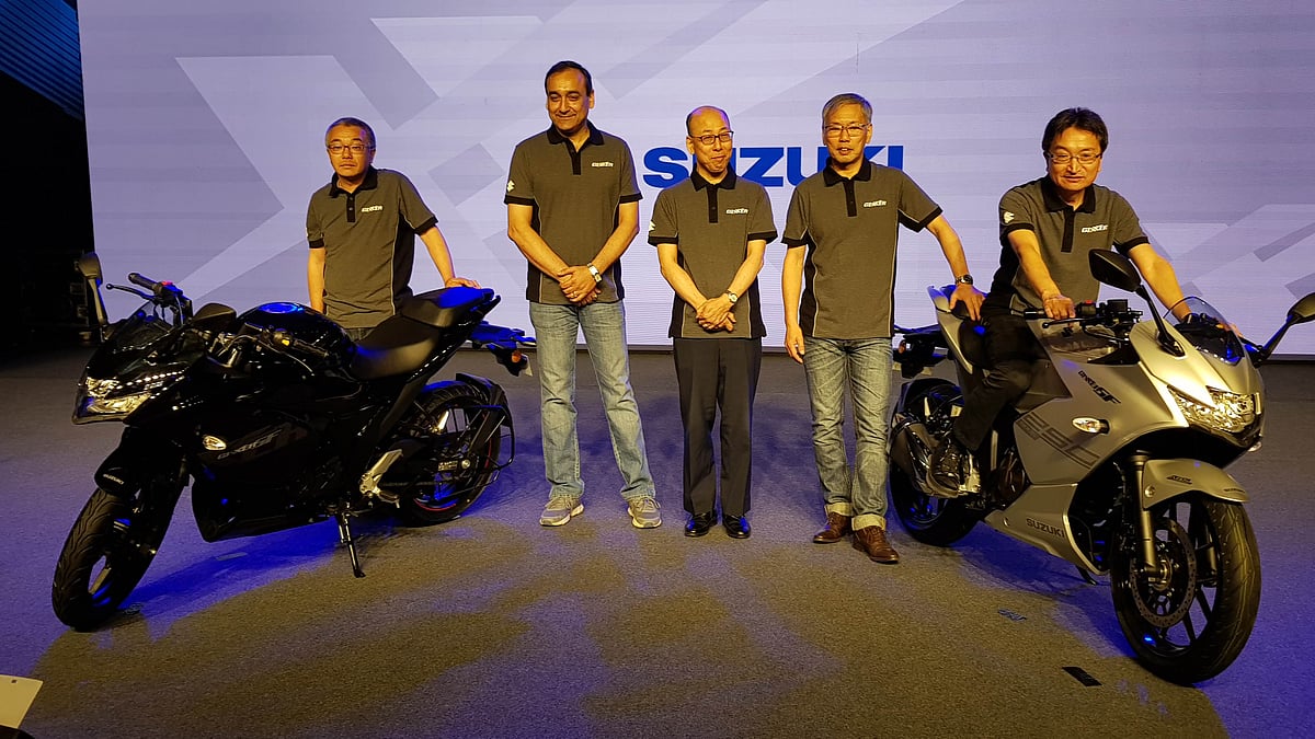 The Suzuki Gixxer SF 150 (left) and Suzuki Gixxer SF 250 (right) with the top management at the company. 