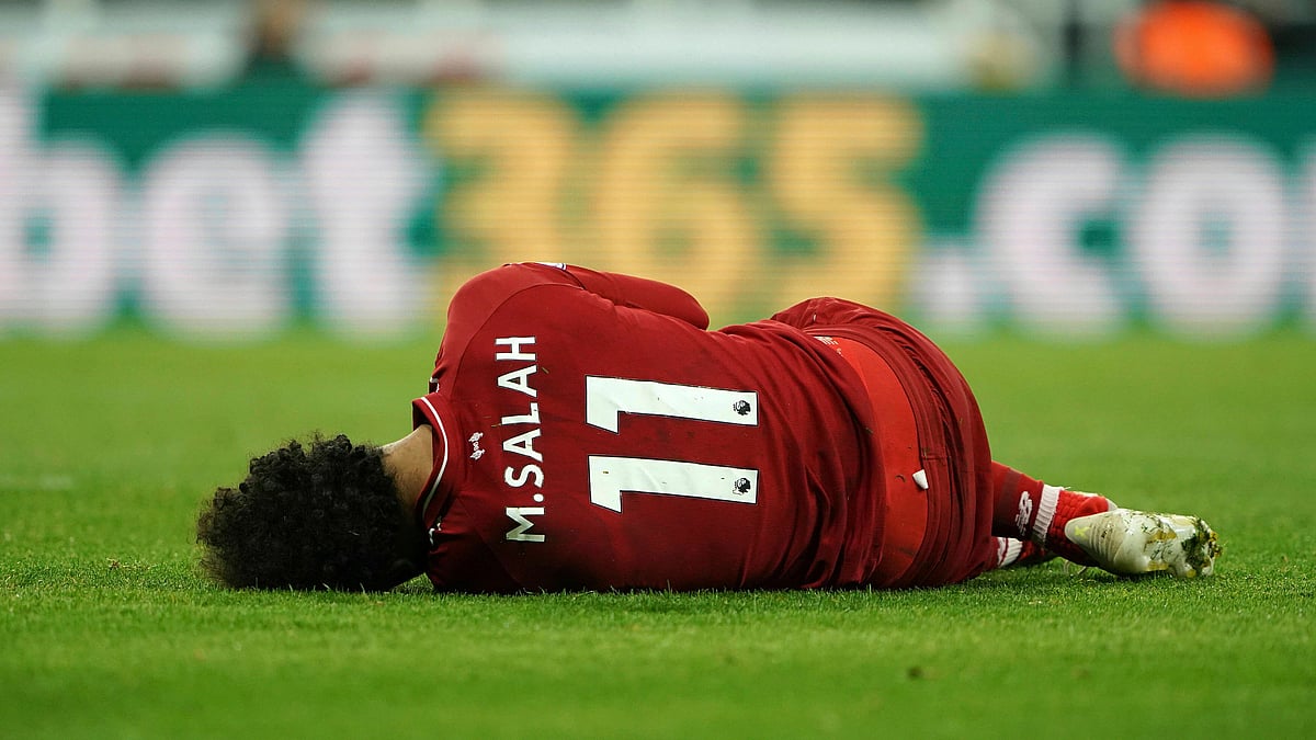 Liverpool’s Mohamed Salah lies injured during a Premier League match against Newcastle United at St James’ Park, Newcastle, England, Saturday May 4, 2019.