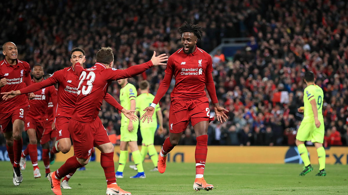 Liverpool’s Divock Origi, center, celebrates scoring his side’s fourth goal of the game during the Champions League Semi Final, second leg soccer match between Liverpool and Barcelona at Anfield, Liverpool. 