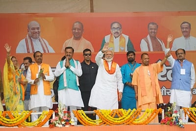 Bhadohi: Prime Minister Narendra Modi accompanied by Uttar Pradesh Chief Minister Yogi Adityanath and Deputy Chief Minister Keshav Prasad Maurya, waves to crowd during his public rally, in Bhadohi, Uttar Pradesh, on May 5, 2019. (Photo: IANS) * *