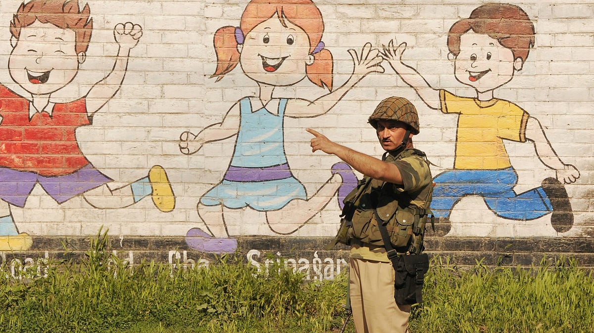 A security person stands guard on the second day of curfew imposed to maintain law and order problem following the killing of most wanted militant and Commander-in-Chief of Ansar Gazwatul Hind Zakir Musa, in Srinagar.