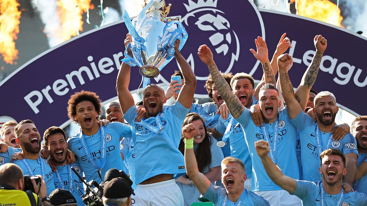 Manchester City lifts the premier league trophy at the AMEX Stadium in Brighton.