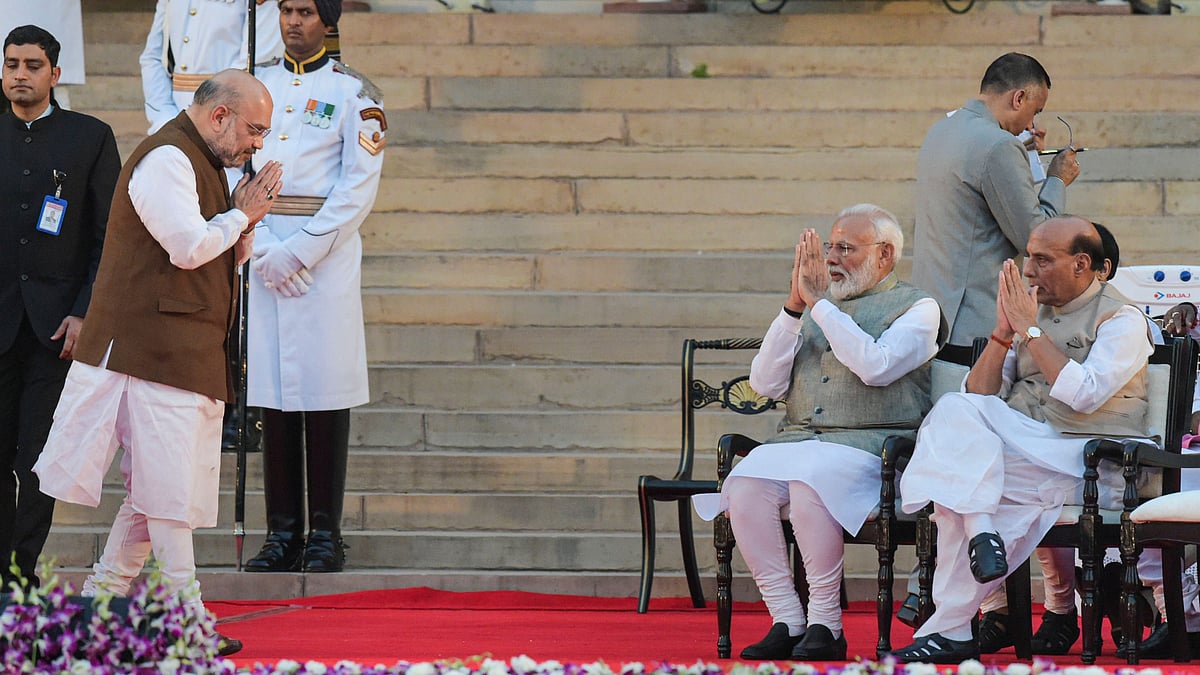 Amit Shah exchanges greetings with Prime Minister Narendra Modi after he took oath as a Cabinet minister.