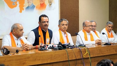 Gandhinagar: Rajasthan BJP chief Jitubhai Vaghani along with former Congress MLA and prominent Koli community leader Kunwarji Bawalia, addresses at the party headquarter, in Gandhinagar on July 3, 2018. Accusing Congress President Rahul Gandhi of playing caste politics and ignoring the aspirations of senior leaders, Bawalia on Tuesday quit as a legislator to join the ruling BJP. He will be sworn in as a minister in the state cabinet later in the evening. (Photo: IANS/Twitter/@BJP4Gujarat)