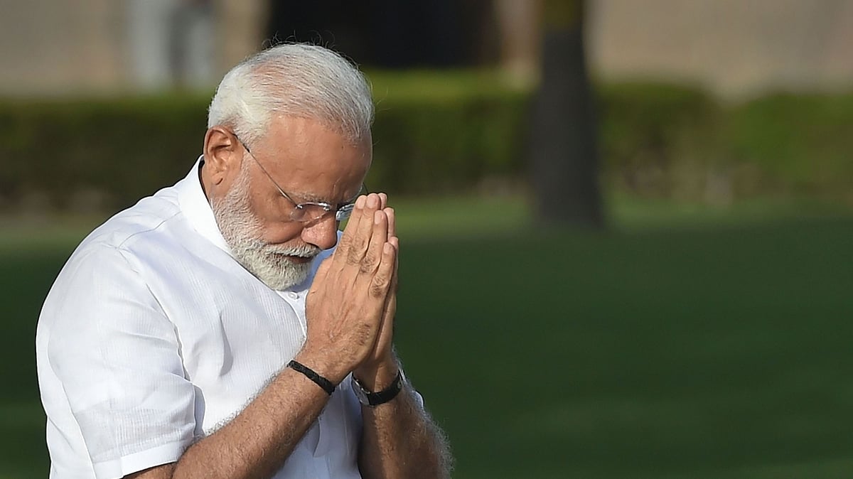 Narendra Modi pays tribute at Mahatma Gandhi memorial, ahead of his swearing-in ceremony, in New Delhi.