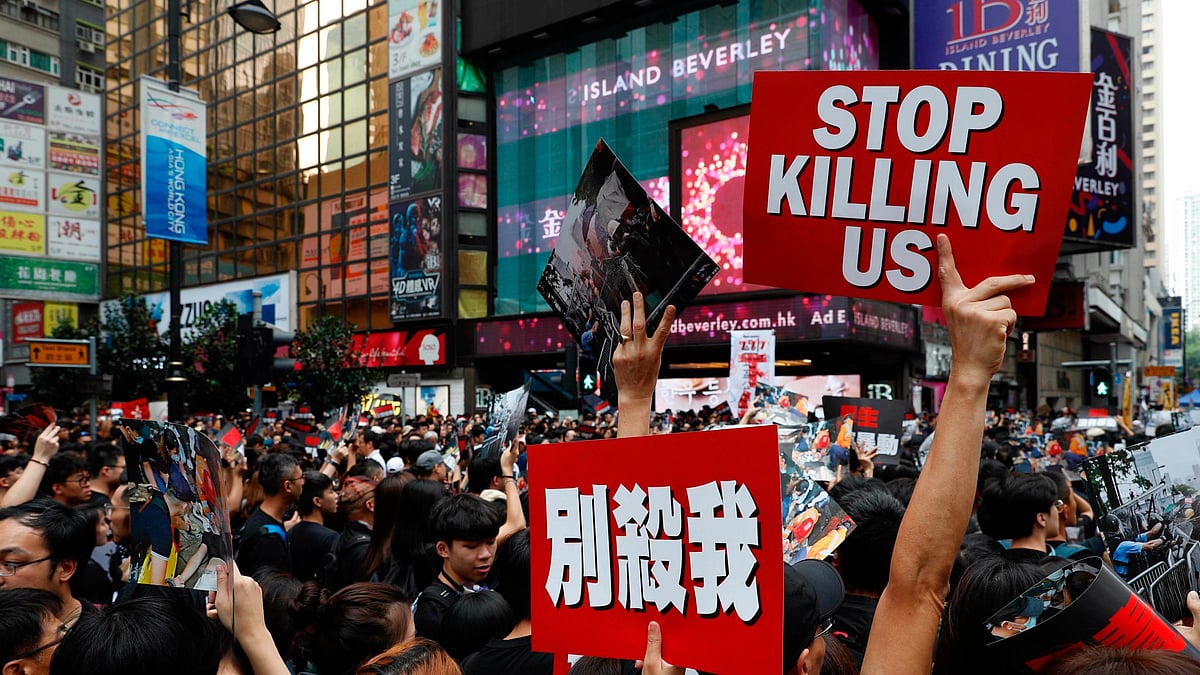 Protesters march on the streets against an extradition bill in Hong Kong on Sunday, 16 June 2019. 