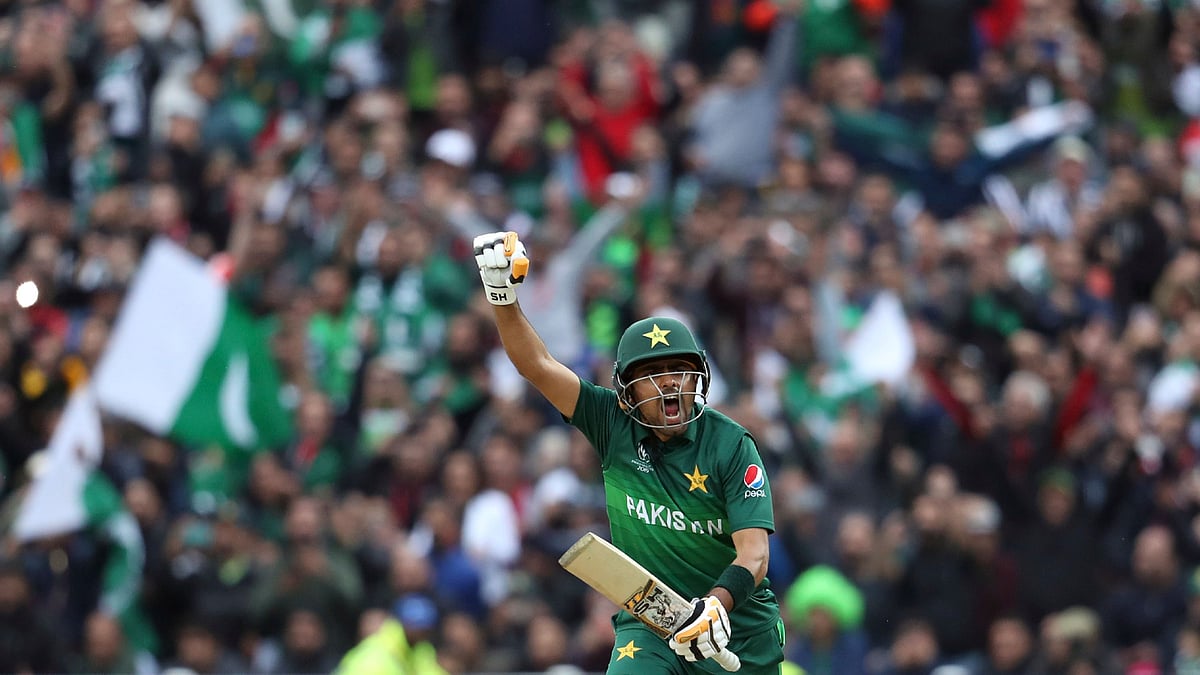 Pakistan’s batsman Babar Azam raises his fist celebrate scoring a century.