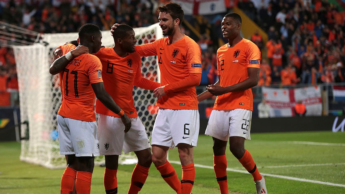 Netherlands’ Quincy Promes (left) celebrates with teammates after scoring his side’s third goal.