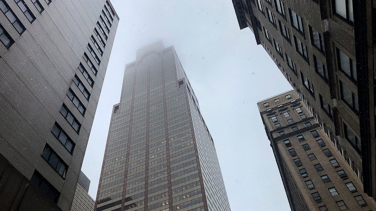 Mist and smoke cover the top of a building near 51st Street and 7th Avenue Monday, June 10, 2019, in New York, where a helicopter was reported to have crash landed on top of the roof of a building in midtown Manhattan. 