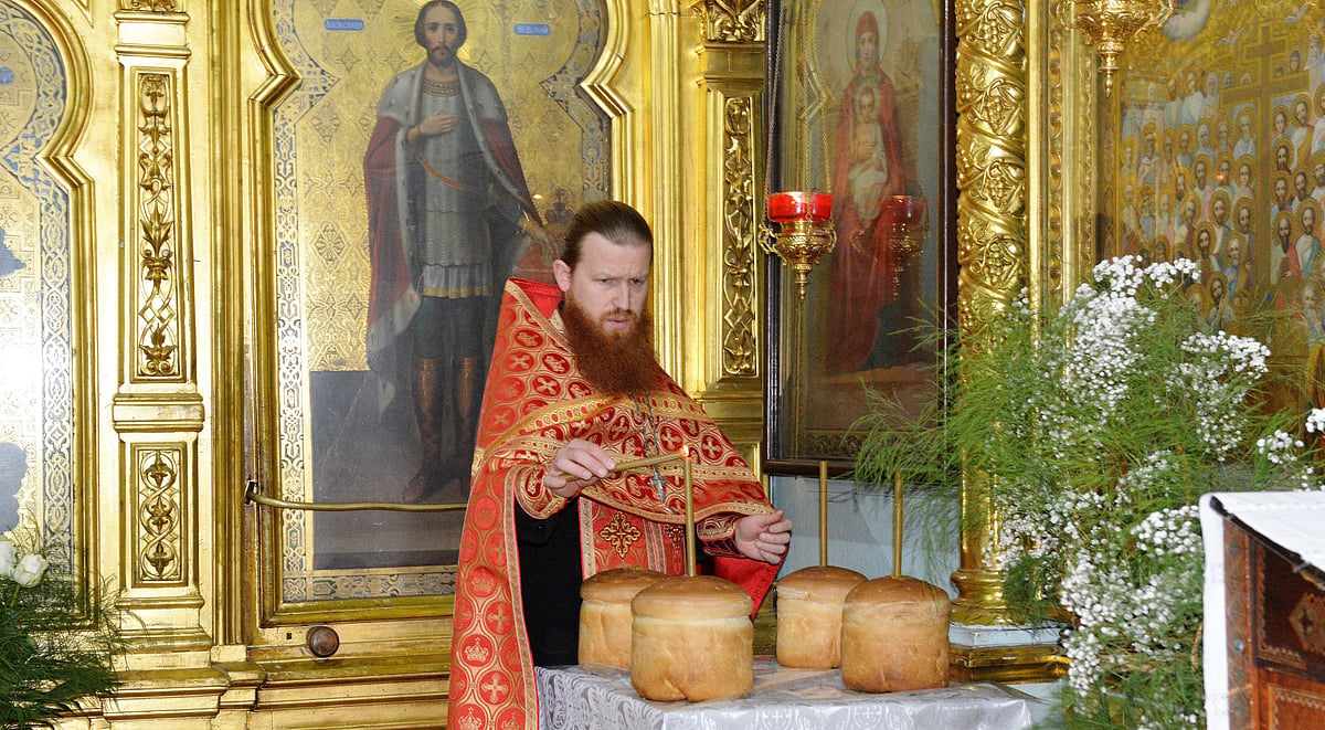 A priest lights a candle inside St Theodor Tiron Cathedral in Moldova’s capital Chisinau