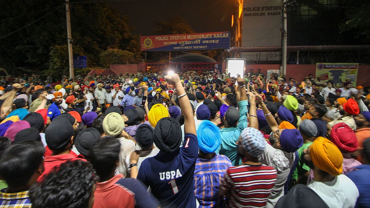 Protestors gather outside Mukherjee Nagar Police Station.