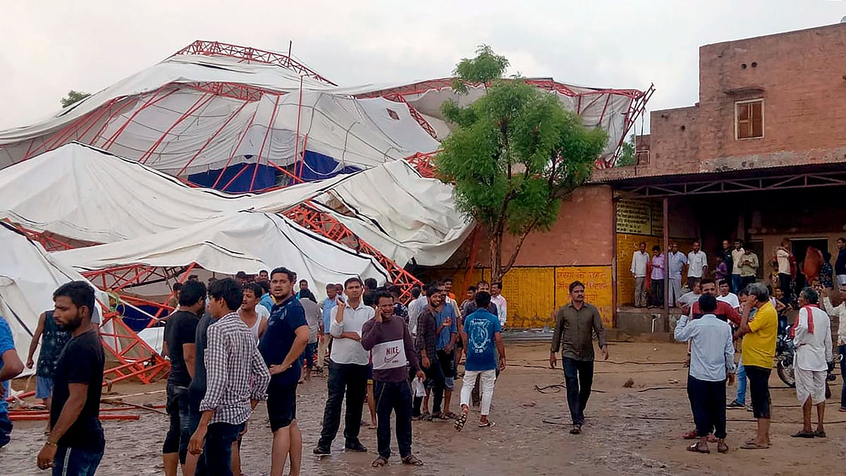 Panic-stricken people after a pandal fell during a Ram Katha due to a storm in Jasol village of Barmer district.