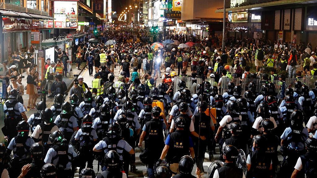 Layers of police officers face-off with protesters in Hong Kong on Sunday, 7 July. 
