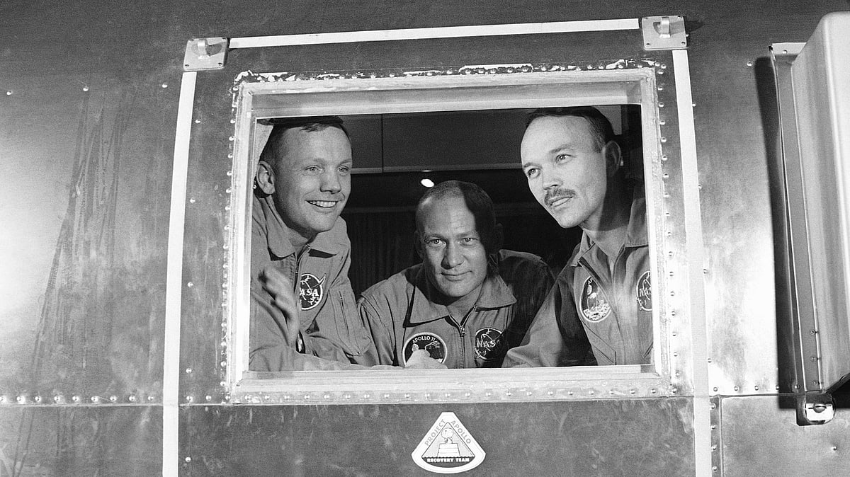 In this 27 July 1969 file photo, Apollo 11 crew members, from left, Neil Armstrong, Buzz Aldrin and Michael Collins sit inside a quarantine van in Houston.