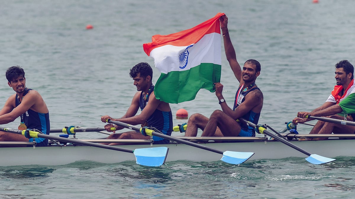 File picture of Indian rowing Men’s team member Bhokanal Dattu holds the national flag as he celebrates after winning the gold medal in Men’s Quadruple Sculls.