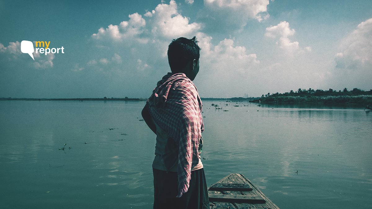 A fisherman stands atop his boat.