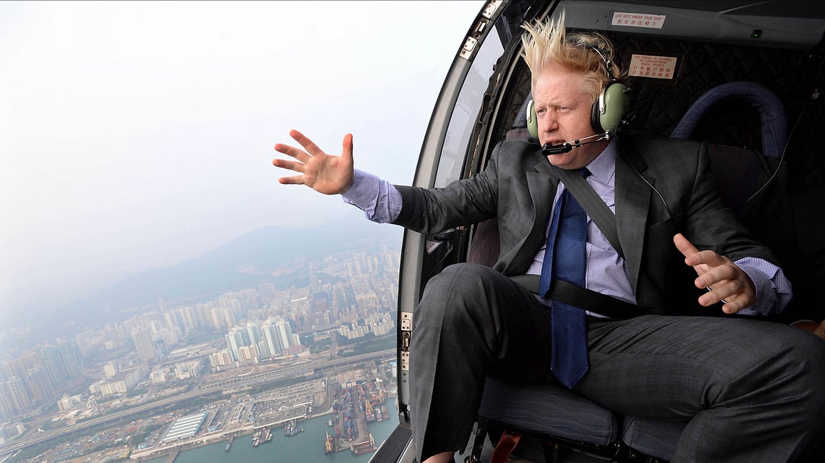 In this 2013 file photo, the then Mayor of London Boris Johnson looks at the skyline during a helicopter ride over Hong Kong.