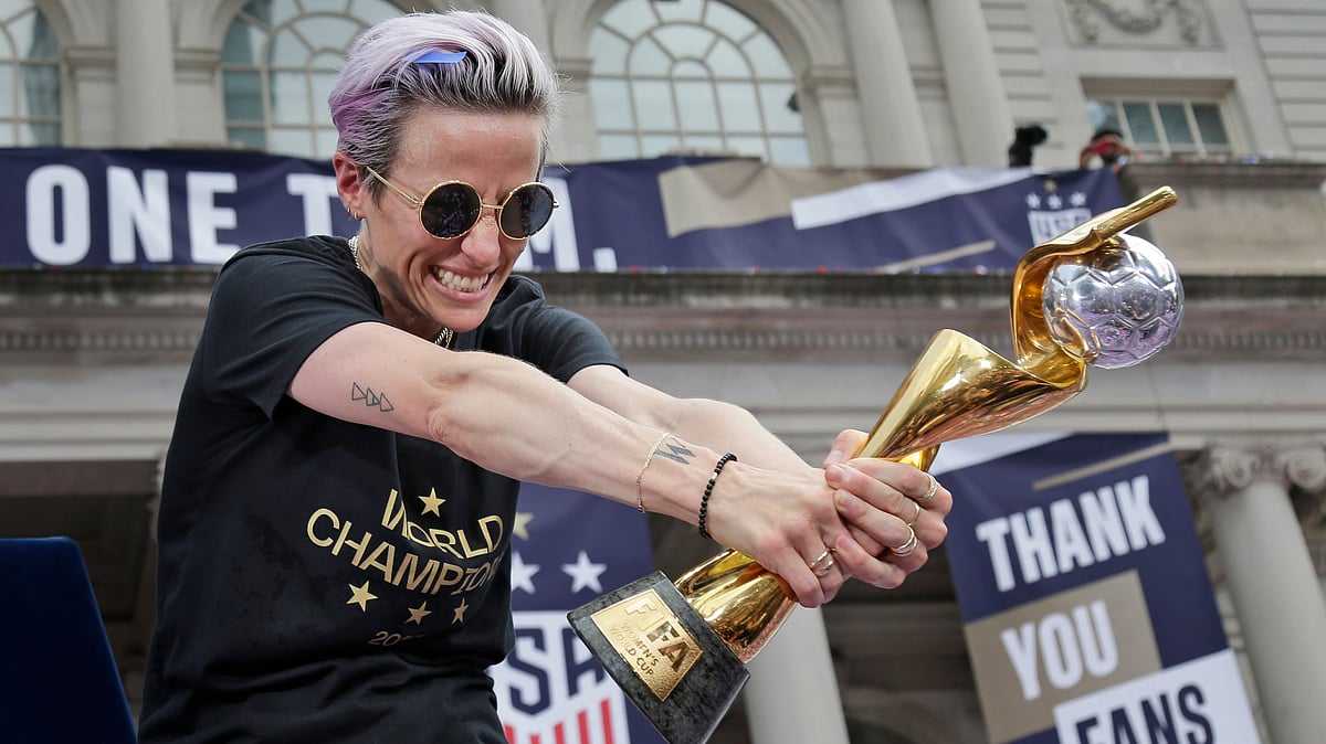 Megan Rapinoe holding the FIFA Women World Cup trophy