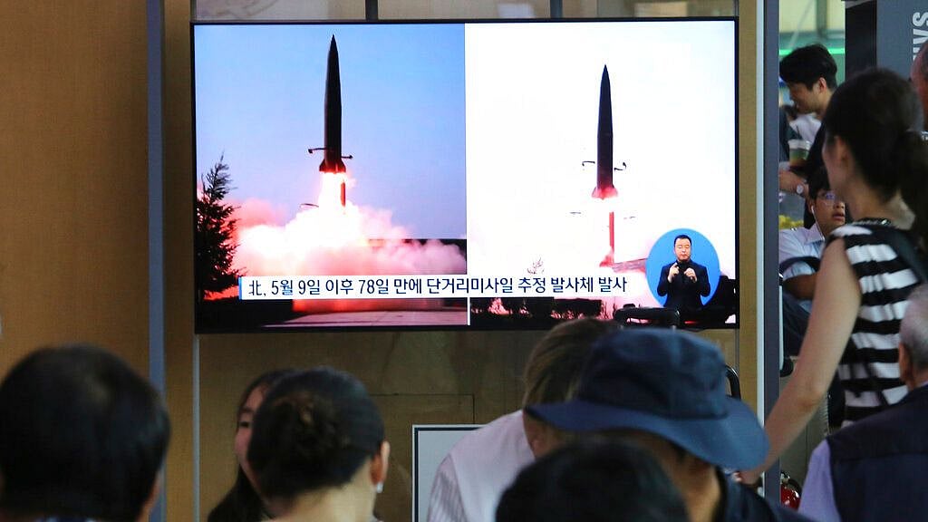 People watch a TV showing file images of North Korea’s missile launch during a news program at the Seoul Railway Station in Seoul, South Korea on 25 July 2019. 