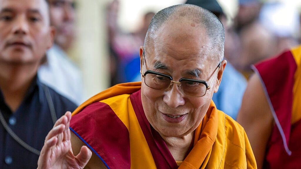 Tibetan spiritual leader the Dalai Lama greets devotees as he arrives at the Tsuglakhang temple in Dharmsala on 5 July 2019. 