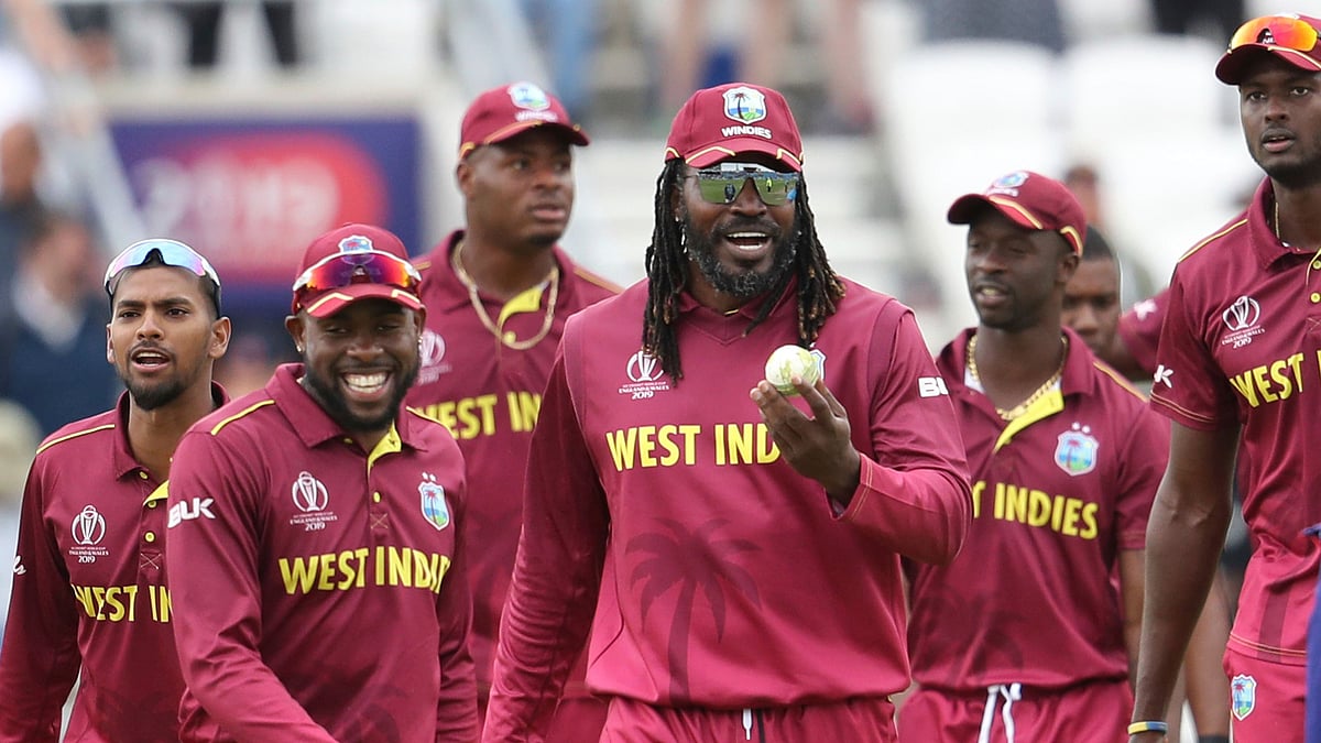 Chris Gayle leads the West Indies team off the field after helping them beat Afghanistan in their last match of the 2019 ICC World Cup.