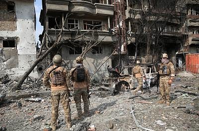 KABUL, July 29, 2019 (Xinhua) -- Afghan security force members inspect at the site of an attack in Kabul, capital of Afghanistan, July 29, 2019. The death toll of a terrorist attack that targeted the office of Afghan President Mohammad Ashraf Ghani
