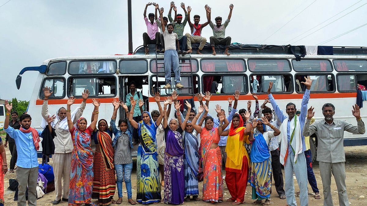 Amarnath Yatra pilgrims chant religious slogans outside a base camp in Jammu on 2 August 2019.&nbsp;