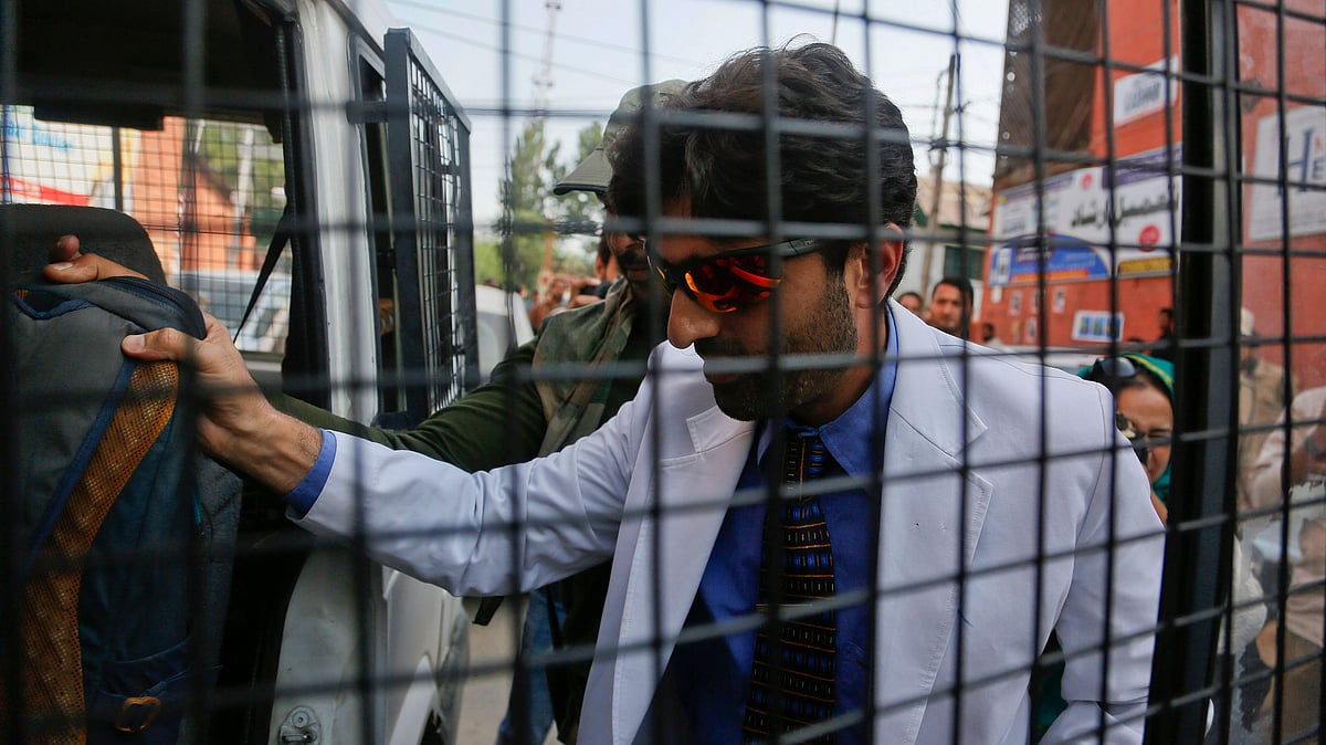 Indian police take away Kashmiri man Omar, a doctor who demanded restoration of landline and internet connectivity in hospitals in Srinagar.