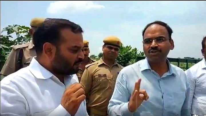 BSP Leader Madan Ram and Ballia DM Bhawani Singh Khangaraut.
